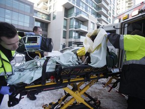 Toronto paramedics load a suspect in a double stabbing into an ambulance on Wednesday, Dec. 13, 2017. (Ernest Doroszuk/Toronto Sun)