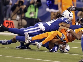 Indianapolis Colts strong safety Matthias Farley (41) tackles Denver Broncos wide receiver Emmanuel Sanders (10) in the first half of an NFL football game in Indianapolis, Thursday, Dec. 14, 2017.