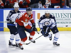 The Winnipeg Jets will be without pest defenceman Dustin Byfuglien, right, when they host the Vancouver Canucks on Monday. They'll still be favoured against their injury-riddled visitors.
