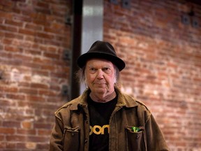 Canadian musician Neil Young leaves a news conference in Vancouver, B.C., on Monday, November 23, 2015. Neil Young is officially headed back to his hometown of Omemee, Ont., for an intimate concert on Friday night, but good luck scoring last-minute tickets.