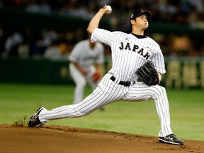 In this Nov. 19, 2015, file photo, Japan's starter Shohei Otani pitches against South Korea