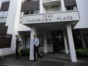 RCMP officers leave an apartment building in Richmond on May 4, 2014 after Jin 'Jenna' Cheng was stabbed to death by her estranged husband.