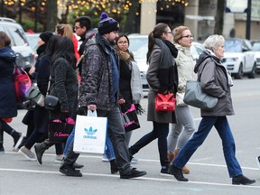 Boxing Day shoppers on Robson Street in downtown Vancouver on Tuesday.
