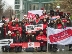 Joban Bal (centre top) and volunteers recruit blood donors at Burrard and Dunsmuir streets in Vancouver on Jan. 27. Bal is a University of B.C. student passionate about blood donations and has set up a donation clinic at 888 Dunsmuir.