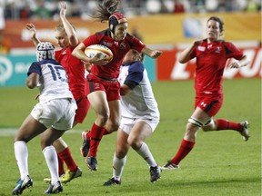 Canada's Brittany Waters, centre, takes possession of the ball, during the semi final match of the Women's Rugby World Cup 2014 between France and Canada, at the Jean Bouin stadium, in Paris, on August 13, 2014. Veteran back Brittany Waters, who played at three Rugby World Cups and two Sevens World Cups for Canada, has announced her retirement. The 34-year-old Vancouver native will continue with the sport in her role as coach of the University of Victoria women's team.