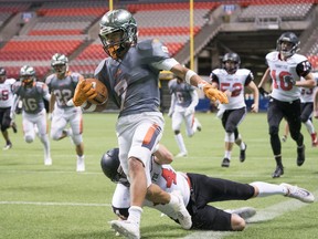 New West Hyacks Sebastien Reid is dragged out of bounds by Terry Fox Ravens Eric Polan during the BC High School triple-A football championships at BC Place on Saturday.