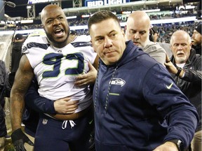 Members of the Seattle Seahawks staff escort Seattle Seahawks defensive tackle Quinton Jefferson (99) from the field after he got into a shouting match with fans, when objects were thrown at him, in the closing moments of an NFL football game against the Jacksonville Jaguars Dec. 10.