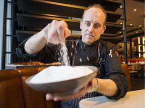 Jeffery Young, presidents of the B.C. Chef's Association sprinkles salt into a bowl. Health Canada has just wrapped up consultations with the restaurant and food supply industry and will try to come up with a plan — either voluntary or mandatory — to reduce salt in restaurant meals to be implemented by the end of 2019.