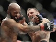 Tim Elliott, right, hits Demetrious Johnson during their flyweight bout last year in Las Vegas. Elliot fights again this weekend, and the strong showing he put in against Johnson makes him one of the more interesting fights.