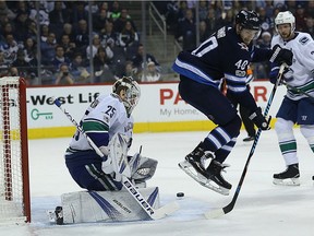 Winnipeg Jets' forward Joel Armia jumps in front of Vancouver Canucks' goaltender Jacob Markstrom in Winnipeg on Monday. The Jets won the all-Canadian NHL battle 5-1.