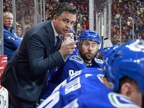Head coach Travis Green of the Vancouver Canucks looks on from the bench during their October game against the Winnipeg Jets at Rogers Arena.