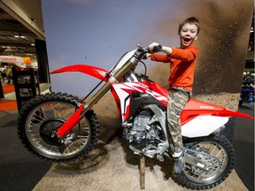 Triston Kolke, 7, happily sits on a Honda 450R.