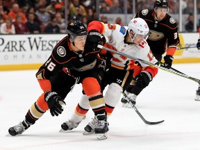 Brandon Montour of the Ducks, left, defends against Johnny Gaudreau of the Calgary Flames during NHL action at the Honda Center on Dec. 29, 2017 in Anaheim, Calif.