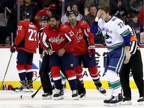 Devante Smith-Pelly and Ben Hutton skate to the penalty box after a spirited scrap.