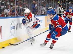 Ty Smith (left) of the Spokane Chiefs vies for the puck with Edmonton Oil King Ethan Cap during a WHL game last October at Rogers Place in Edmonton.