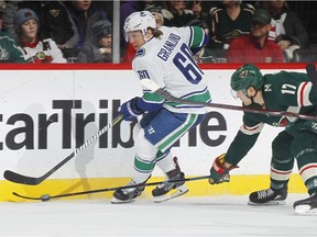 Markus Granlund #60 of the Vancouver Canucks skates with the puck against Marcus Foligno #17 of the Minnesota Wild during the game at the Xcel Energy Center on January 14, 2018 in St. Paul, Minnesota.