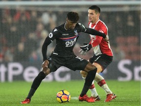 Crystal Palace's Ivorian striker Wilfried Zaha, left, vies with Southampton's Serbian midfielder Dusan Tadic during the English Premier League match at St. Mary's Stadium in Southampton, southern England, on Jan. 2.