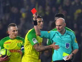 Nantes' Brazilian defender Diego Carlos (C) receives a red card during the French L1 football match between Nantes and Paris Saint-Germain (Paris-SG) at the La Beaujoire stadium in Nantes, western France, on January 14, 2018.