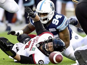 Ottawa Redblacks quarterback Trevor Harris fumbles the ball as Toronto Argonauts defensive end Victor Butler completes the tackle during CFL action on July 24, 2017
