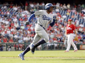 Los Angeles Dodgers' Curtis Granderson, left, rounds the bases after hitting a home run off Philadelphia Phillies pitcher Mark Leiter Jr. during the sixth inning of a baseball game in Philadelphia on September 21, 2017. THE CANADIAN PRESS/AP, Matt Slocum