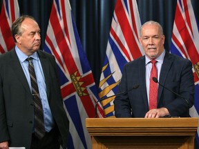 Green party Leader Andrew Weaver keeps his eye on Premier John Horgan while he addresses the media last September. The two are not currently seeing eye to eye on a future for the liquefied natural gas (LNG) industry in B.C.