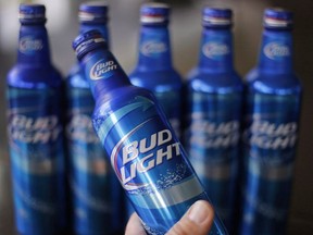 In this Monday, April 7, 2014, file photo, aluminum bottles of Bud Light beer are on display at Alcoa headquarters in Pittsburgh. Ordering a standard, big-brand beer in one Brandon, Manitoba restaurant can leave your wallet hammered a lot more than you.