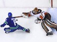 Vancouver Canucks' Brock Boeser takes a shot against Ryan Miller of the Anaheim Ducks.