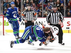 Michael Chaput of the Canucks fights Chris Wagner Ducks.