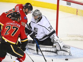 Flames Troy Brouwer (L) goes for an open puck and then scores behind Kings goalie Jonathan Quick during NHL action between the Los Angeles Kings and the Calgary Flames in Calgary on Thursday, January 4, 2018.