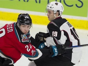Dawson Holt of the Vancouver Giants, right, battles with Braydyn Chizen of the Kelowna Rockets earlier this month in WHL action at the Langley Events Centre.