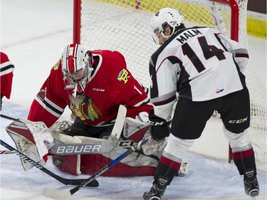 Vancouver Giants #14 James Malm looks for the puck as Portland Winterhawks goalie Shane Farkas stops a shot in the first period of a regular season WHL hockey game at LEC, Vancouver, January 20 2018.