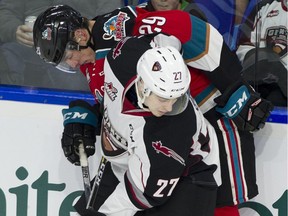 Vancouver Giants defence-man Brennan Riddle and Kelowna Rockets forward Nolan Foote look for the puck along the boards in the first period of WHL hockey action at LEC Saturday.