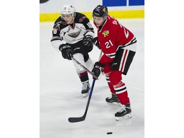 Vancouver Giants #16 Davis Koch and Portland Winterhawks #21 Brendan De Jong chase after the puck in the first period of a regular season WHL hockey game at LEC, Vancouver, January 20 2018.