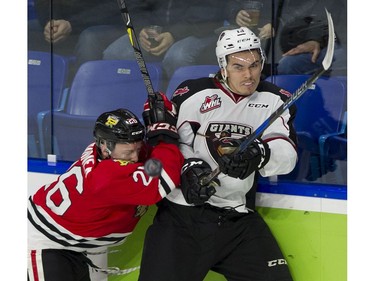 Vancouver Giants #16 Davis Koch and Portland Winterhawks  #43 Skyler McKenzie crask along the boards in the first period of a regular season WHL hockey game at LEC, Vancouver, January 20 2018.