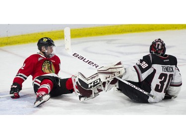 Vancouver Giants goalie Davis Tendeck and Portland Winterhawks #12 Jaydon Dureau crash to the ice in the first period of a regular season WHL hockey game at LEC, Vancouver, January 20 2018.