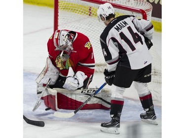 Vancouver Giants #14 James Malm looks for the puck as Portland Winterhawks goalie Shane Farkas stops a shot in the first period of a regular season WHL hockey game at LEC, Vancouver, January 20 2018.
