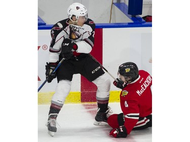 Vancouver Giants #21 Aidan Barfoot gets hung up on the stick of Portland Winterhawks #4 Connor MacEeacher, in the second period of a regular season WHL hockey game at LEC, Vancouver, January 20 2018.