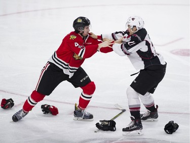 Vancouver Giants #21 Aidan Barfoot and Portland Winterhawks #4 Connor MacEeacher fight in the second period of a regular season WHL hockey game at LEC, Vancouver, January 20 2018.