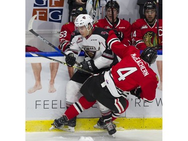 Vancouver Giants #21 Aidan Barfoot and Portland Winterhawks #4 Connor MacEeacher, crash along the boards in the second period of a regular season WHL hockey game at LEC, Vancouver, January 20 2018.