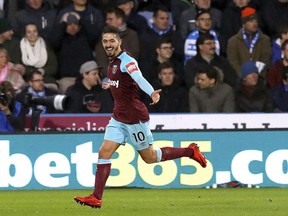 West Ham United's Manuel Lanzini celebrates scoring his side's fourth goal of the game against Huddersfield Town during the English Premier League soccer match against West Ham United at the John Smith's Stadium, Huddersfield, England, Saturday Jan. 13, 2018.