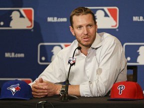 FILE - In this Dec. 9, 2013, file photo, two-time Cy Young Award winner Roy Halladay answers questions after announcing his retirement after 16 seasons in the major leagues with Toronto and Philadelphia, at the MLB winter meetings in Lake Buena Vista, Fla. An autopsy report says Halladay had evidence of amphetamine, morphine and an insomnia drug in his system when he died in a small plane crash in Florida last year.
