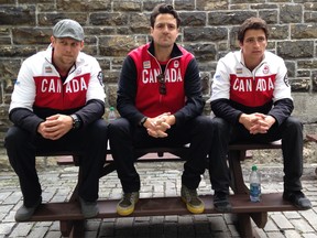 Jesse Lumsden, Sam Edney and Scott Moir contemplate the 2018 Olympic Games in this photo taken on Parliament Hill in Ottawa in 2014.
