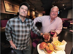 Chef Jim Romer, left, with partner Kelly Gordon, in action at Romer's Burgers in Vancouver. Romer's Burgers has made some innovative changes to attract staff.