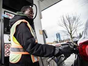 An attendee fills up a costumers vehicle with gas at Superstore Gas Bar at Lougheed Hwy and Westwood St. in Coquitlam in this 2016 file photos. Coquitlam and Richmond both ban self-service gas stations, something the oil companies would like to change.