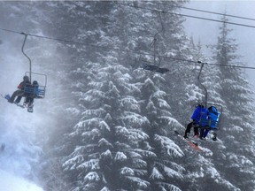 Skiers on a Cypress Mountain chair lift in December.