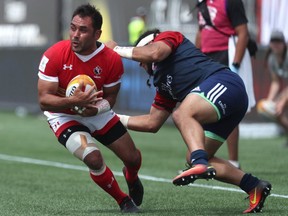 Canada's Phil Mack (left) avoids a tackle from Mike Te'o of USA during a 2019 Rugby World Cup Qualifier at Tim Horton's Field in Hamilton, Ont. on Saturday, June 24, 2017. The game finished in a 28-28 tie.