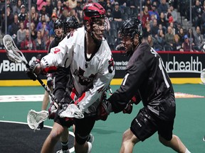 Tony Malcom of the Vancouver Stealth tries to make his way around a Colorado Mammoth defender on Friday.