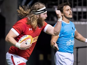 Canada's Evan Olmstead, left, celebrates after scoring a try as Uruguay's Nicolas Freitas looks on during the first half of a Rugby World Cup qualifier match in Vancouver, B.C., on Saturday January 27, 2018.