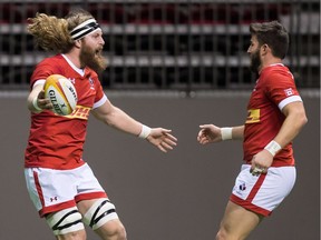 Canada's Evan Olmstead, left, celebrates with DTH van der Merwe after scoring a try against Uruguay during the first half of a Rugby World Cup qualifier match in Vancouver, B.C., on Saturday January 27, 2018.