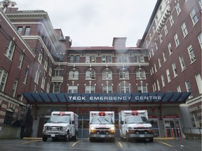 Three ambulances sit at St. Paul's Hospital in Vancouver, April 23, 2015.